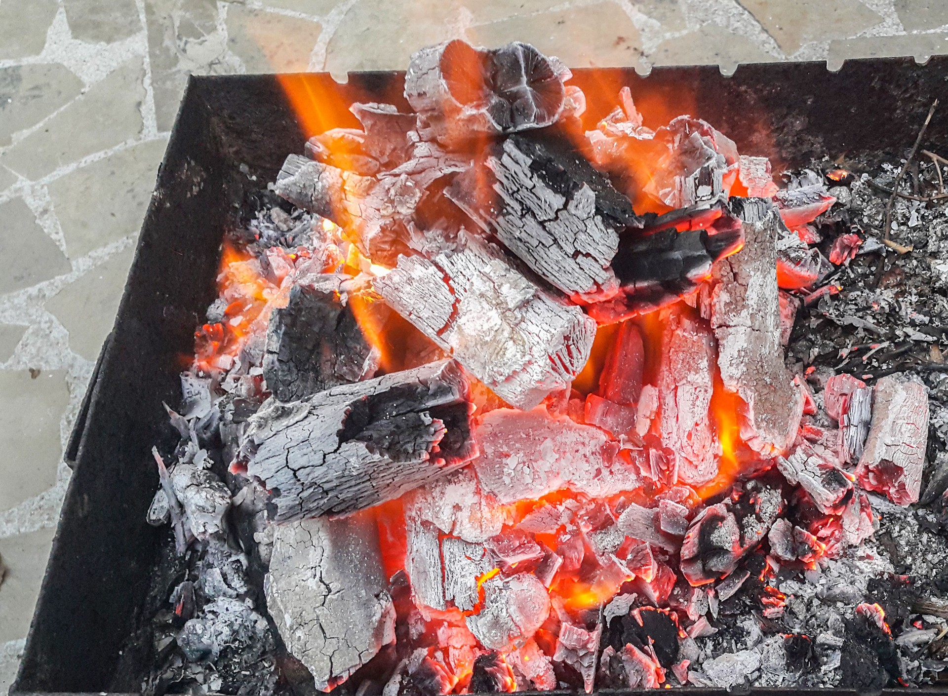 Close-up of Burning coal. Glowing embers smoldering in the fireplace.
