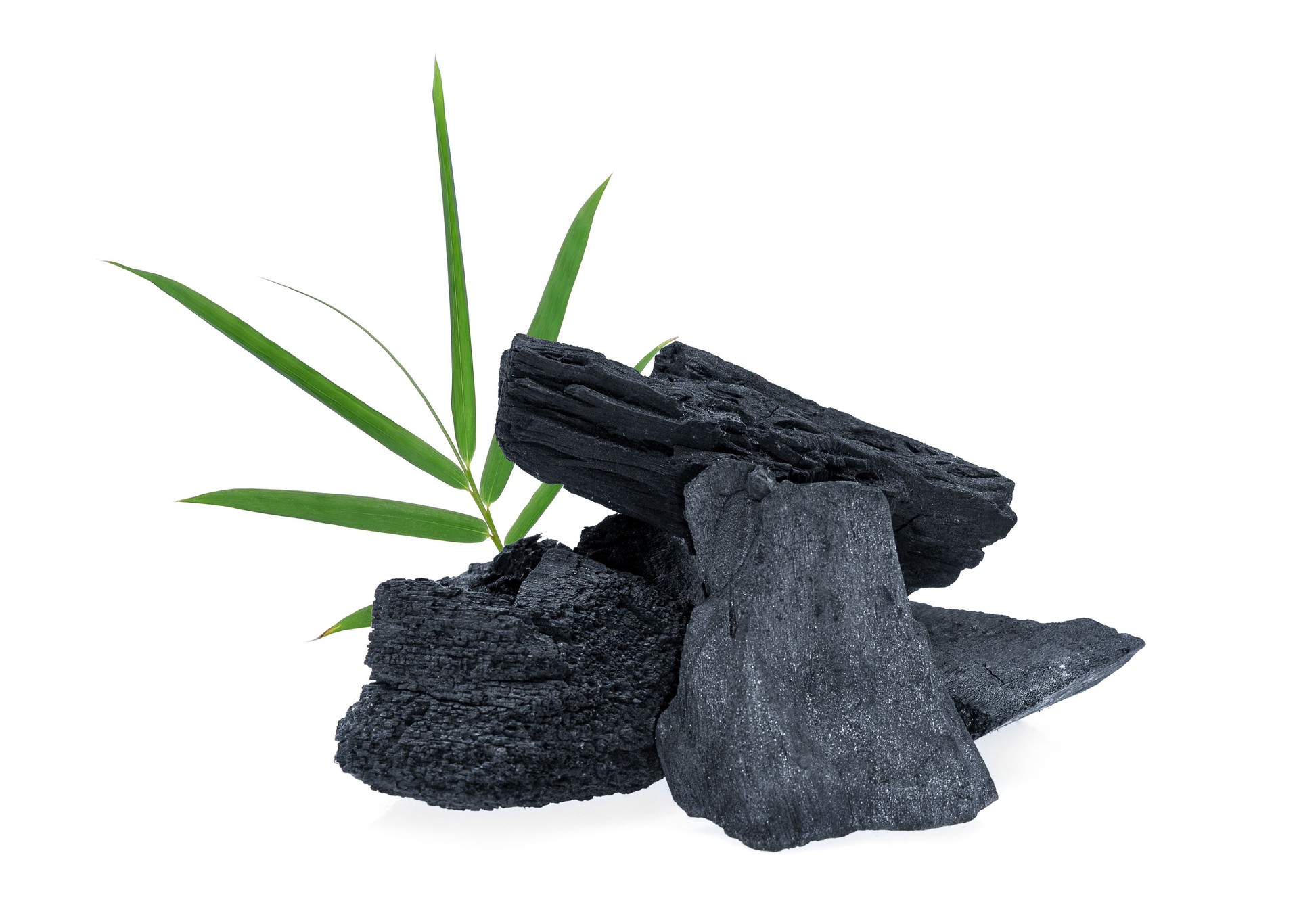 wood charcoal with bamboo leaf isolated on white background