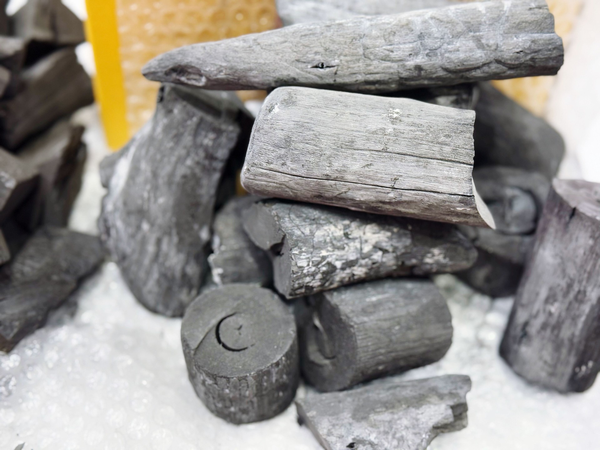 Black coal in a pile on a white background, close-up